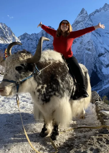 a women happy sitting on bull